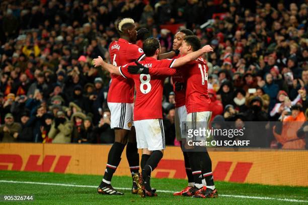 Manchester United's French striker Anthony Martial celebrates scoring their second goal with Manchester United's French midfielder Paul Pogba ,...