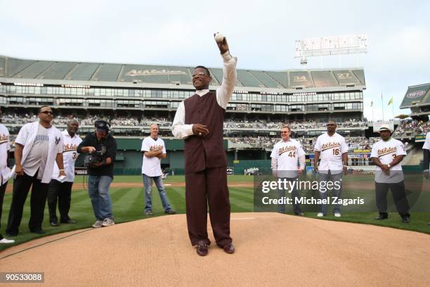 Rickey Henderson prepares to throw out the first pitch during a ceremony to retire his jersey prior to the Oakland Athletics game against the Toronto...