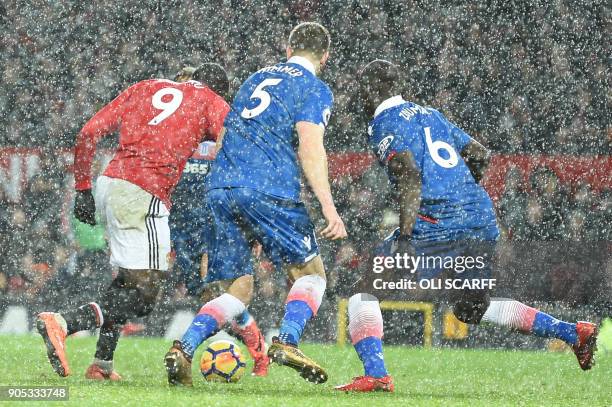 Manchester United's Belgian striker Romelu Lukaku prepares to strike the ball to score their third goal during the English Premier League football...