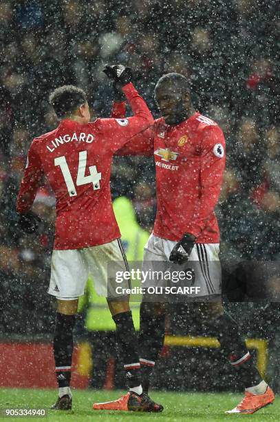 Manchester United's Belgian striker Romelu Lukaku celebrates with Manchester United's English midfielder Jesse Lingard after scoring their third goal...