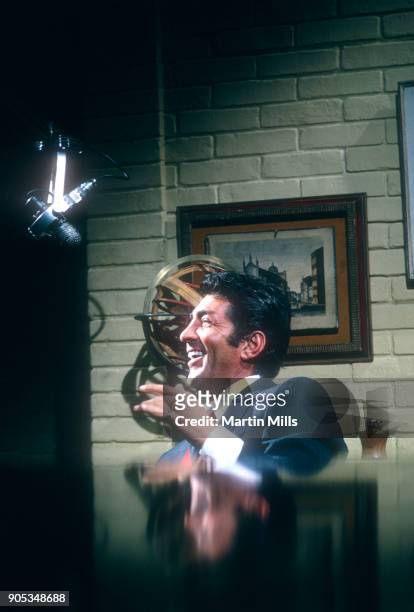 American singer, actor and comedian Dean Martin laughs during the taping of 'The Dean Martin Variety Show' circa 1967 in Los Angeles, California.