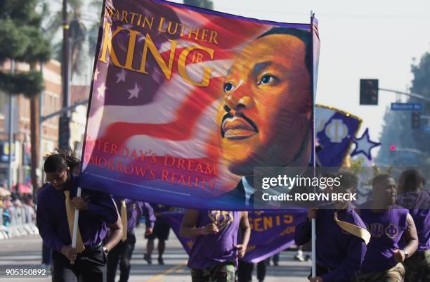 Participants march in the 33rd annual Kingdom Day Parade honoring Dr. Martin Luther King Jr., January 15, 2018 in Los Angeles, California. The theme...