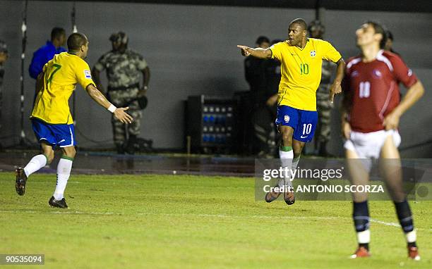Brazil's Julio Baptista celebrates with teammate Daniel Alves after scoring as Chile's Gonzalo Jara reacts during their FIFA World Cup South...