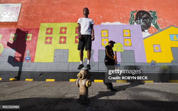 Dwight Marshall, a student at Wilder's Preparatory Academy Charter School in Inglewood awaits the start of the 33rd annual Kingdom Day Parade...