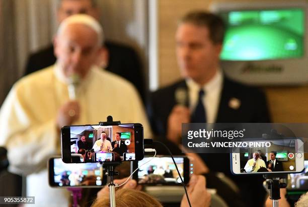 Pope Francis welcomes journalists on board the plane on the way to Santiago at the start of his seven-day trip to Chile and Peru, on January 15,...