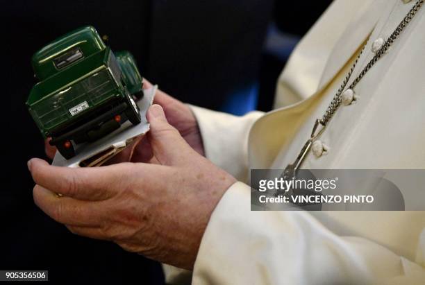 Pope Francis receives a model of the truck used by Chilean priest Father Hurtado, canonized in 2005 by Pope Benedict XVI, as a gift as he welcomes...