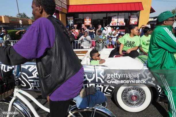 Boy sitting in a car watches the 33rd annual Kingdom Day Parade honoring Dr. Martin Luther King Jr., January 15, 2018 in Los Angeles, California. The...