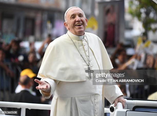 Pope Francis smiles at the faithful from the Popemobile in Santiago, on January 15, 2018. - Pope Francis is visiting Chile from January 15 to 18,...