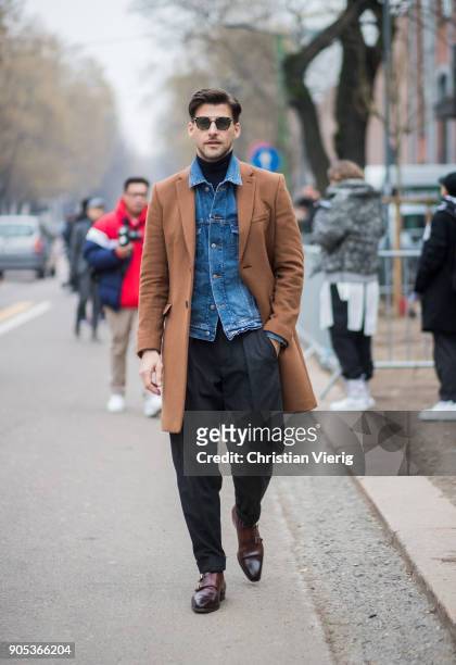 Johannes Huebl wearing denim jacket, brown wool coat, black wide leg pants, brown leather shoes is seen outside Fendi during Milan Men's Fashion Week...