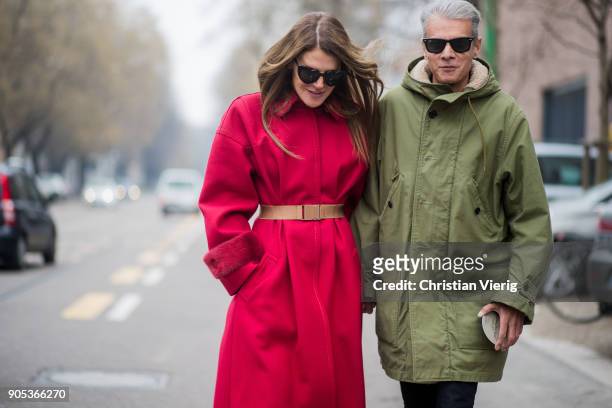 Couple Anna dello Russo wearing red coat with brown belt, black ankle boots and Angelo Gioia is seen outside Fendi during Milan Men's Fashion Week...