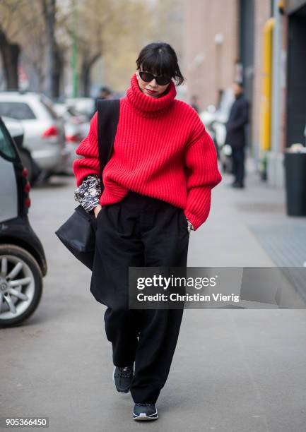 Yoyo Lu wearing red turtleneck, black wide leg pants is seen outside Fendi during Milan Men's Fashion Week Fall/Winter 2018/19 on January 15, 2018 in...