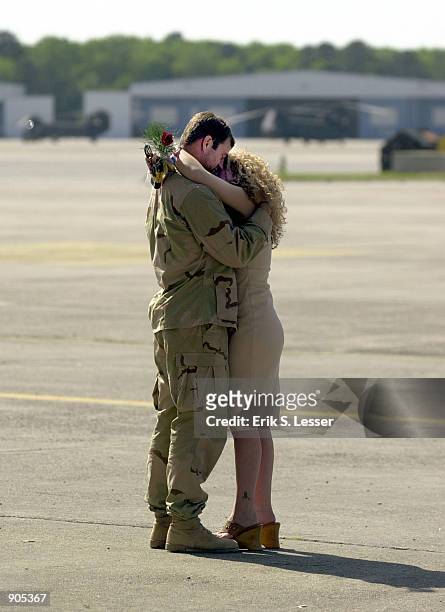 Army Ranger Sgt. Jason Hillebrand kisses his wife Kelly after returning from a four-month deployment in Afghanistan in support of Operation Enduring...