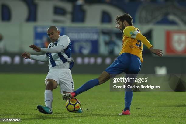 Porto's defender Maxi Pereira from Uruguay vies with GD Estoril Praia defender Joel Ferreira from Portugal for the ball possession during the match...