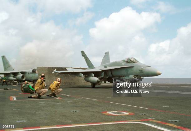 Navy F/A-18 "Hornet" aircraft takes off from the flight deck of the USS George Washington aircraft carrier June 26, 2000 located on the waters near...