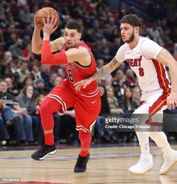 Chicago Bulls guard Zach LaVine moves to the basket as Miami Heat guard Tyler Johnson defends in the first half of an NBA basketball game at the...