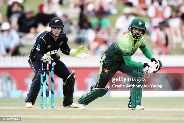 Mohammad Hafeez of Pakistan bats as Tom Latham of New Zealand looks on during game four of the One Day International Series between New Zealand and...