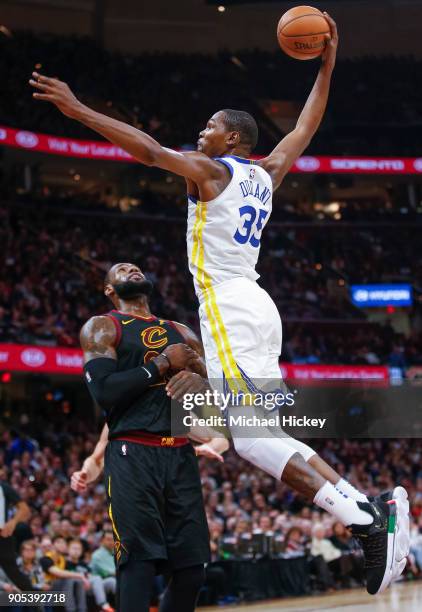 Kevin Durant of the Golden State Warriors goes up for the dunk over LeBron James of the Cleveland Cavaliers at Quicken Loans Arena on January 15,...