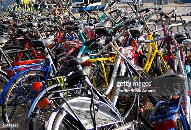 bikes parked outside central station, amsterdam - centraal station stock pictures, royalty-free photos & images