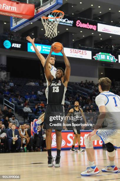 DePaul Blue Demons guard Max Strus blocks a shot from Providence Friars forward Kalif Young during a game between the DePaul Blue Demons and the...