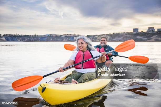 senior mexican couple kayaking - kayaking stock pictures, royalty-free photos & images