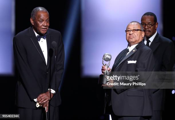 Honoree William Lucy accepts the Chairman's Award from Chairman of the NAACP Board of Directors Leon W. Russell and Bishop Charles Blake onstage...