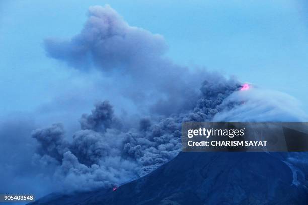 Cloud-covered Mayon volcano spews ash as it erupts near the Philippine city of Legazpi in Albay province, early on January 16, 2018. Thousands fled...