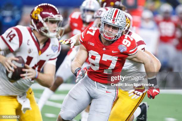 Ohio State Buckeyes defensive end Nick Bosa chases USC Trojans quarterback Sam Darnold out of the pocket during the Cotton Bowl Classic matchup...