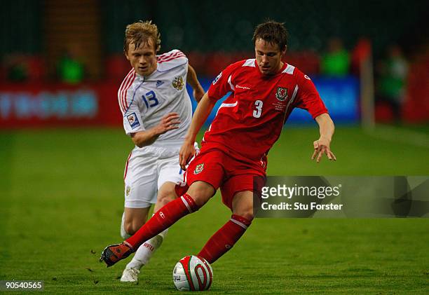 Russia player Renat Yanbaev challenges Chris Gunter during the FIFA 2010 World Cup Group 4 Qualifier between Wales and Russia at the Millennium...