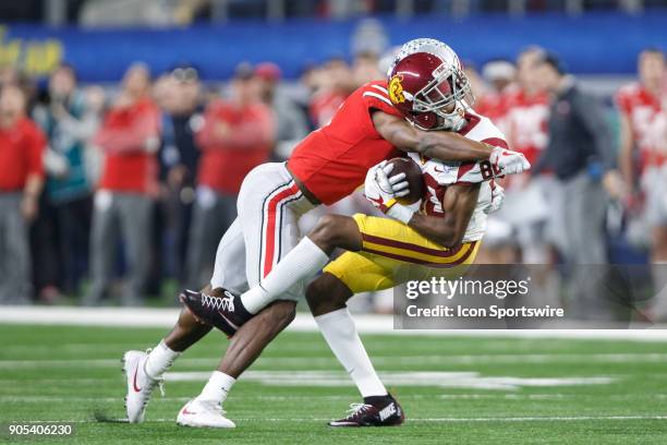 Trojans wide receiver Deontay Burnett is tackled by Ohio State Buckeyes cornerback Kendall Sheffield during the Cotton Bowl Classic matchup between...