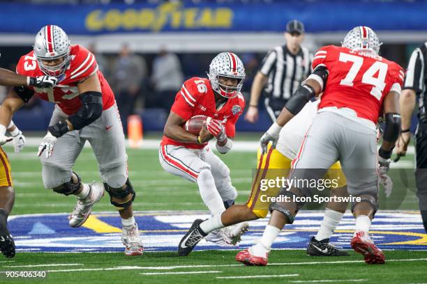 Ohio State Buckeyes quarterback J.T. Barrett looks for room to run during the Cotton Bowl Classic matchup between the USC Trojans and Ohio State...