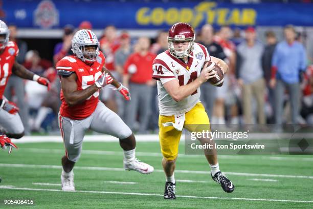 Trojans quarterback Sam Darnold is flushed out of the pocket by Ohio State Buckeyes defensive end Tyquan Lewis during the Cotton Bowl Classic matchup...