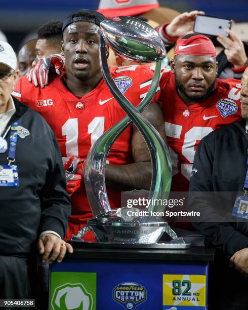 Ohio State Buckeyes defensive ends Tyquan Lewis and Jalyn Holmes with the trophy during the Cotton Bowl Classic matchup between the USC Trojans and...