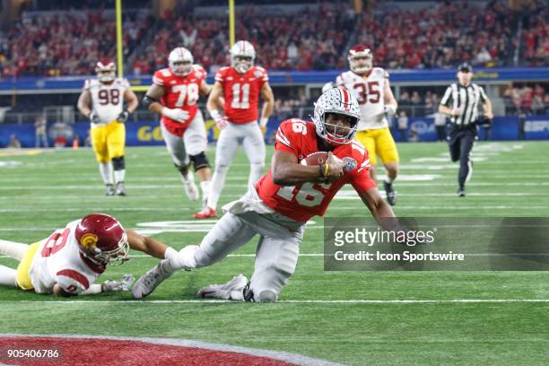 Ohio State Buckeyes quarterback J.T. Barrett falls into the end zone for a touchdown during the Cotton Bowl Classic matchup between the USC Trojans...