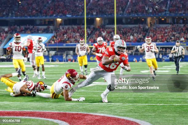Ohio State Buckeyes quarterback J.T. Barrett falls into the end zone for a touchdown as USC Trojans cornerback Iman Marshall tries to make the tackle...