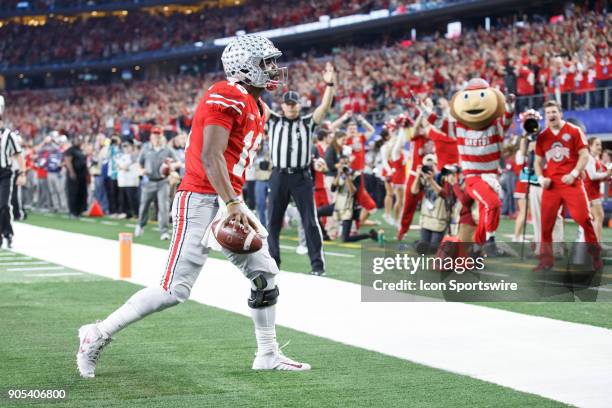 Ohio State Buckeyes quarterback J.T. Barrett celebrates a touchdown during the Cotton Bowl Classic matchup between the USC Trojans and Ohio State...