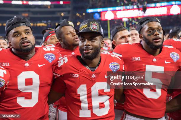 Ohio State Buckeyes linebacker Baron Browning , quarterback J.T. Barrett and defensive tackle Jashon Cornell celebrate during the Cotton Bowl Classic...
