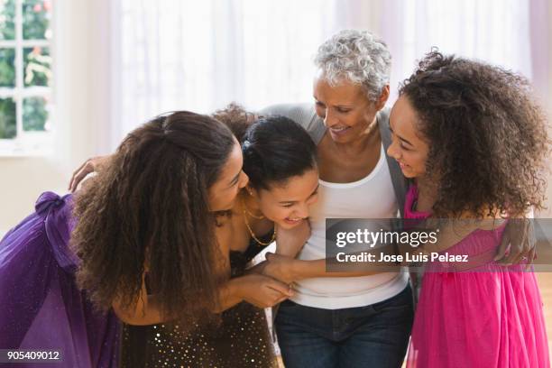 girls embracing grandmother on a hug before going to the  homecoming dance - homecoming dance stock pictures, royalty-free photos & images