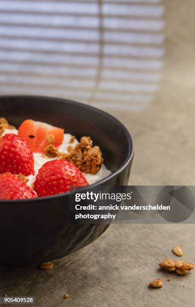 sheep yoghurt topped with strawberries and granola. - body sugars stock pictures, royalty-free photos & images