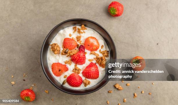 sheep yoghurt topped with strawberries and granola. - body sugars stock pictures, royalty-free photos & images