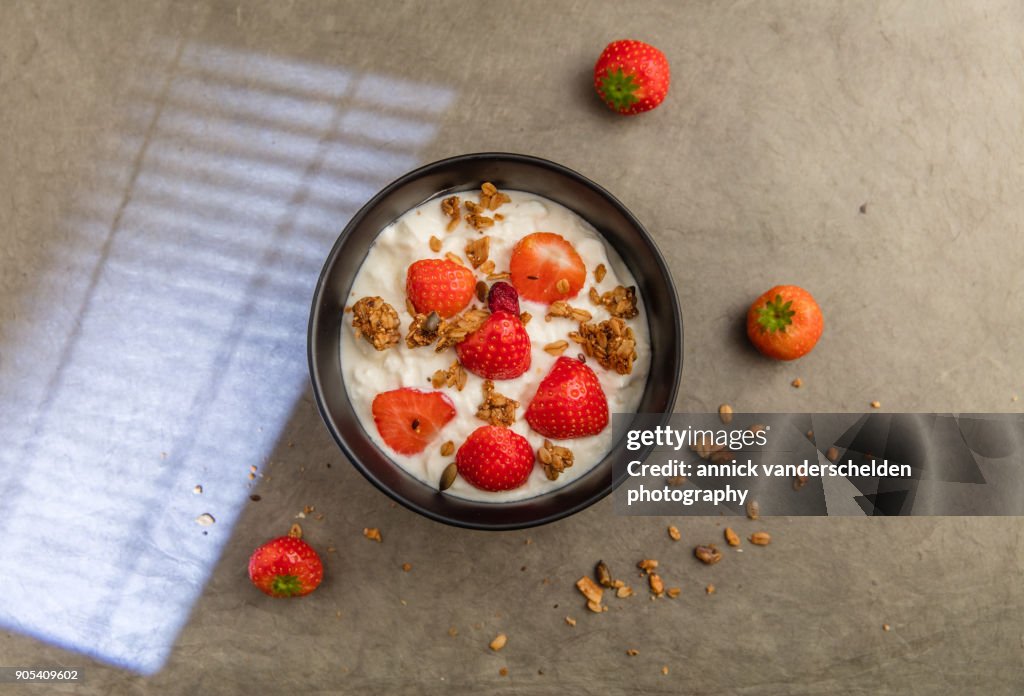 Sheep yoghurt topped with strawberries and granola.