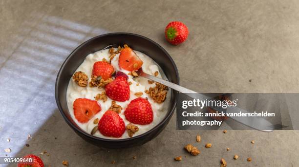 sheep yoghurt topped with strawberries and granola. - body sugars stock pictures, royalty-free photos & images