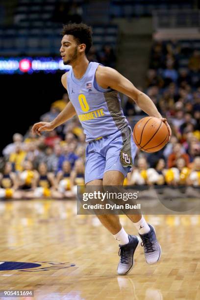 Markus Howard of the Marquette Golden Eagles dribbles the ball in the first half against the DePaul Blue Demons at the BMO Harris Bradley Center on...