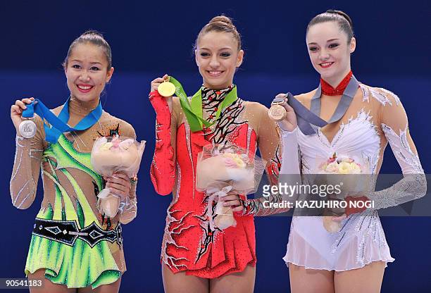 Champion Evgenia Kanaeva of Russia , second-placed Aliya Garayeva of Azerbaijan and third-placed Anna Bessonova of Ukraine pose on the podium during...