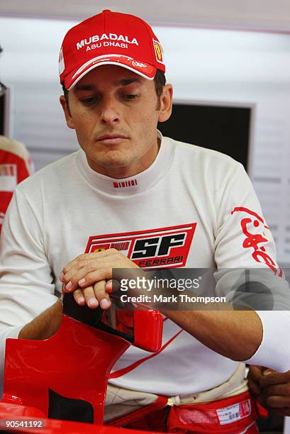 New Ferrari driver Giancarlo Fisichella of Italy familiarises himself with his car in the team garage during previews to the Italian Formula One...