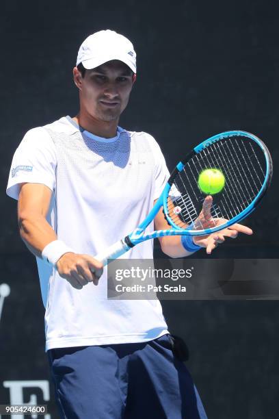 Evgeny Donskoy of Russia plays a backhand in his first round match against Florian Mayer of Germany on day two of the 2018 Australian Open at...