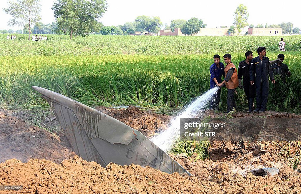 Indian Air Force personnel douse the wre