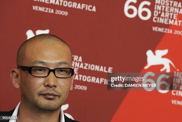 Chinese director Guan Hu poses during the photocall of "Dou Niu" at the Venice film festival on September 10, 2009. "Dou Niu" is competing in the...