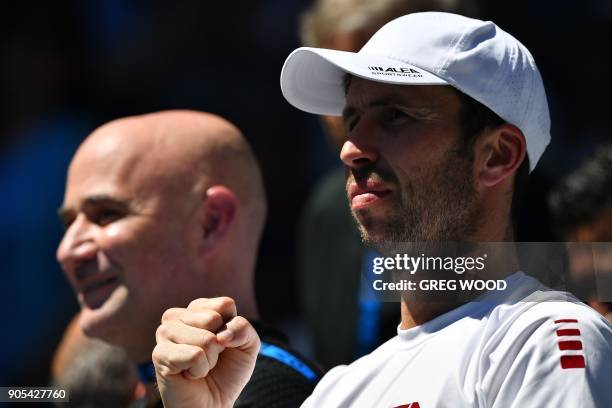 Andre Agassi and Radek Stepanek , part of the coaching team of Serbia's Novak Djokovic watch during his men's singles first round match against...