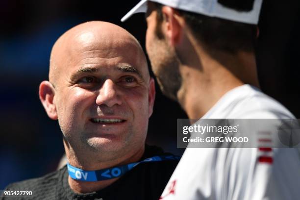 Andre Agassi and Radek Stepanek , part of the coaching team of Serbia's Novak Djokovic watch during his men's singles first round match against...