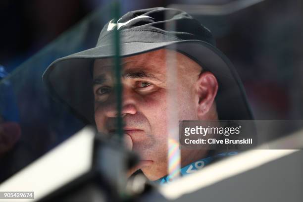 Andre Agassi watches the first round match between Novak Djokovic of Serbia and Donald Young of the United States on day two of the 2018 Australian...